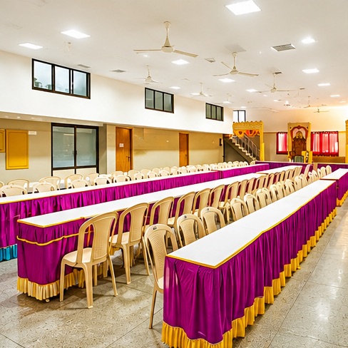 Dining hall with long tables in purple and gold skirting